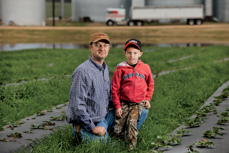 Ben Moore poses for a portrait with his 5 yr. old son Miller. Ben farms 3,500 acres in Weakley County, Tennesee.