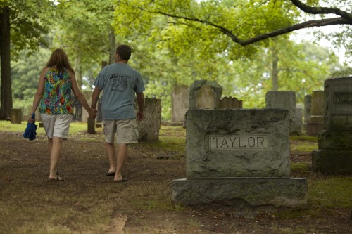 Taylor family members walk throught the cemetery