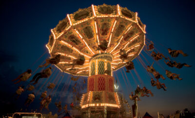 Visitors enjoy riding on the Wave Swinger at dusk at the Wilson County Fair in Lebanon, Tennessee.
