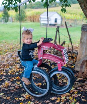 Harper-Lou Armstrong, 2, swings on the tractor swing at Horse Creek Farms in Chuckey, Tennessee. 