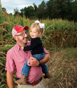 Scott Armstrong holds his daughter, Harper, in the corn maze at Horse Creek Farms in Chuckey. 